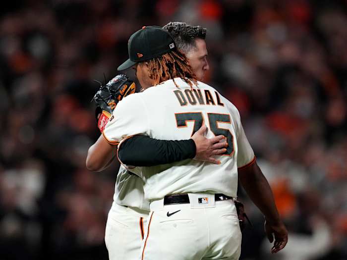 Oct 8, 2021; San Francisco, California, USA; San Francisco Giants catcher Buster Posey (28) hugs relief pitcher Camilo Doval (75) after defeating the Los Angeles Dodgers in game one of the 2021 NLDS at Oracle Park.